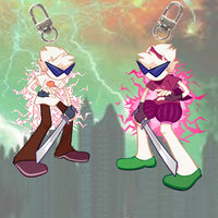 Two anime-style keychain charms with silver keyrings, shown side by side against a green and orange stormy cityscape background. The left charm has white hair, blue sunglasses, brown pants, and purple shoes, surrounded by pink energy lines.